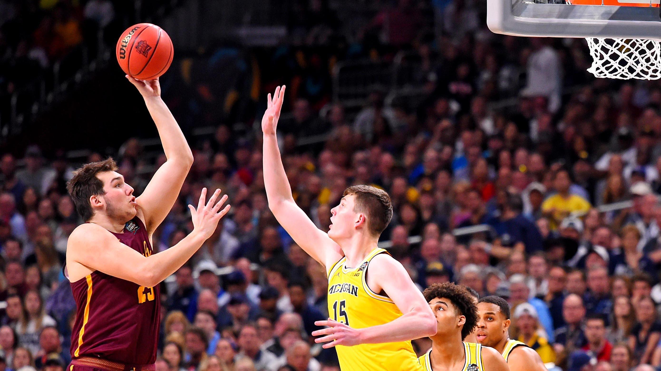 Loyola Chicago's Cameron Krutwig shoots over Michigan's Moritz Wagner