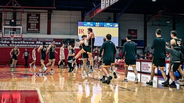 Michigan Tech celebrates with a high-flying chest bump at the Small College Basketball Hall of Fame Classic. 